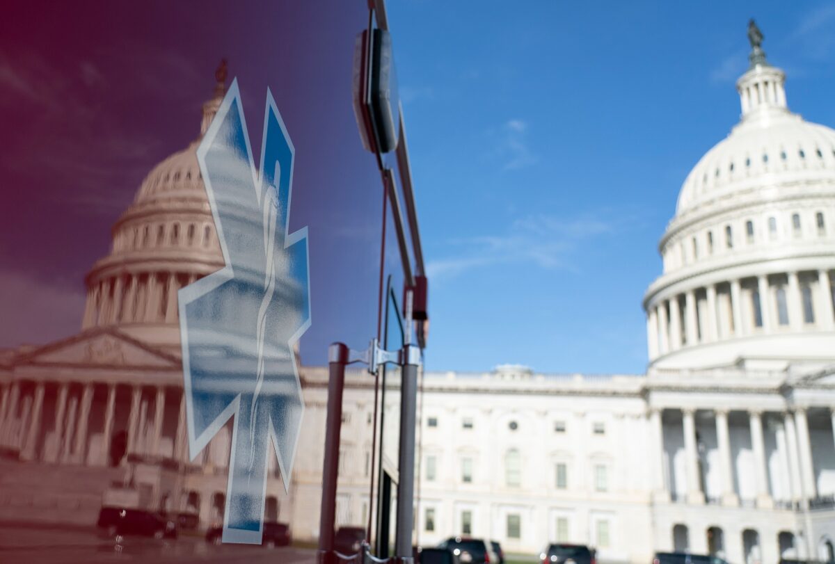Điện Capitol Hoa Kỳ nhìn qua hình phản chiếu trên một xe cứu thương thường trực tại Washington vào ngày 27/3/2020. (Ảnh Alex Edelman/ AFP thông qua Getty Images)