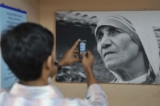 Một cậu bé chụp bức ảnh của Mẹ Teresa được treo trong một toa của tàu "Mother Express" ở Mumbai. Nghiên cứu đã phát hiện ra rằng việc chứng kiến ​​những hành động trắc ẩn phi thường truyền cảm hứng cho những người khác làm điều tốt trong cuộc sống của họ. (Ảnh: Sajjad Hussain/AFP/Getty)