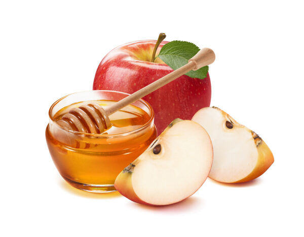 Những trái táo và mật ong. (Ảnh: Shutterstock)