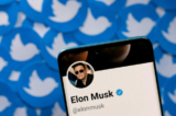 Trang cá nhân Twitter của ông Elon Musk trên một chiếc điện thoại thông minh được đặt trên những tấm logo Twitter in sẵn hôm 28/04/2022. (Ảnh: Dado Ruvic/Illustration/Reuters)