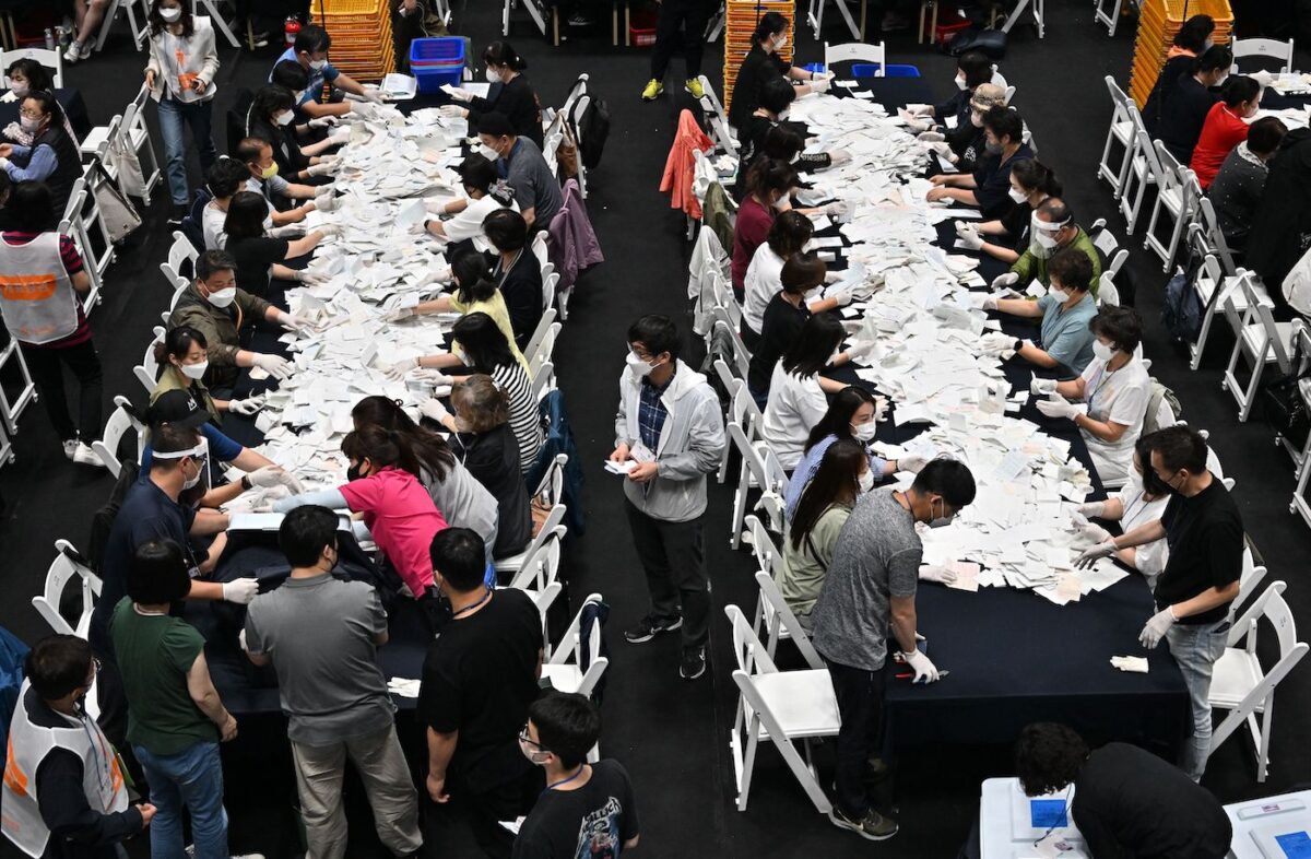 Các quan chức bầu cử Nam Hàn kiểm phiếu cho cuộc bầu cử địa phương trên toàn quốc để bầu ra thị trưởng, thống đốc, thành viên hội đồng địa phương, và trưởng phòng giáo dục khu vực tại một nhà thi đấu ở Seoul, hôm 01/06/2022. (Ảnh: Jung Yeon-je/AFP qua Getty Images)
