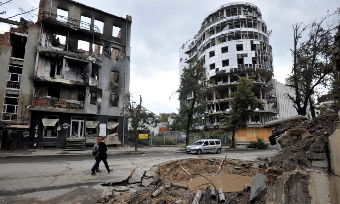 Người dân đi ngang qua một tòa nhà bị phá hủy sau trận pháo kích ở trung tâm Kharkiv, Ukraine, hôm 18/09/2022. (Ảnh: Sergei Chuzavkov/AFP qua Getty Images)