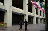 Các nhân viên chấp pháp đi ngang qua Tòa nhà FBI J. Edgar Hoover ở Hoa Thịnh Đốn, hôm 21/07/2022. (Ảnh: Chung I Ho/The Epoch Times)