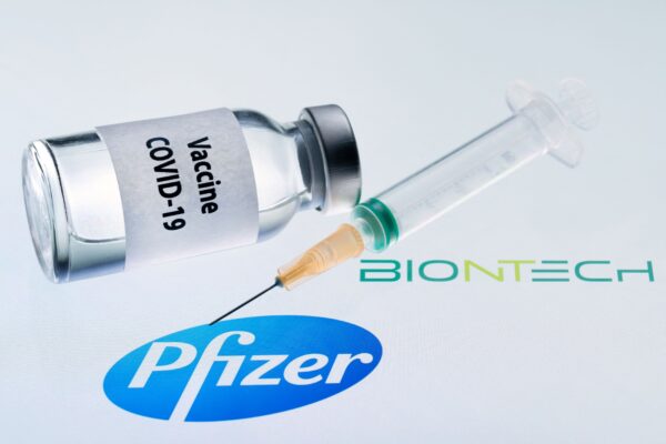 Một lọ thuốc có dòng chữ “Vaccine COVID-19” và một ống chích bên cạnh logo Pfizer và Biontech, vào ngày 23/11/2020. (Ảnh: Joel Saget/AFP qua Getty Images)