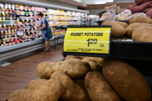 Một người mua hàng đi ngang qua tấm biển ghi giá mỗi pound (0.45kg) khoai tây đỏ tại một siêu thị ở Montebello, Calif., vào ngày 23/08/2022. (Ảnh: Frederic J. Brown/AFP qua Getty Images)