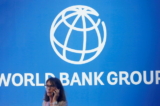 Một người tham gia đứng gần logo của Ngân hàng Thế giới tại Hội nghị Thường niên của Ngân hàng Thế giới - Quỹ Tiền tệ Quốc tế 2018 ở Nusa Dua, Bali, Indonesia, vào ngày 12/10/2018. (Ảnh: Johannes P. Christo/Reuters)