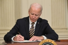 Tổng thống Joe Biden ký sắc lệnh tại Phòng Dạ tiệc Quốc gia của Tòa Bạch Ốc ở Hoa Thịnh Đốn vào ngày 24/02/2021. (Ảnh: Saul Loeb/AFP qua Getty Images)