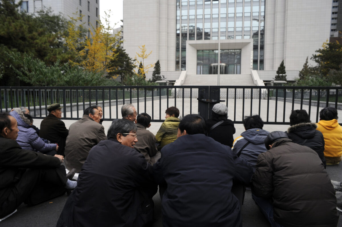 Một nhóm người cao niên về hưu tổ chức một cuộc biểu tình tọa kháng bên ngoài Bộ Tư pháp Trung Quốc về khoản lương hưu không được trả của họ ở Bắc Kinh hôm 08/11/2011. (Ảnh: Goh Chai Hin/AFP/Getty Images)