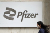 A person walks past a Pfizer logo amid the COVID-19 pandemic in the Manhattan borough of New York, on April 1, 2021. (Carlo Allegri/Reuters)