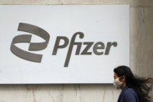 A person walks past a Pfizer logo amid the COVID-19 pandemic in the Manhattan borough of New York, on April 1, 2021. (Carlo Allegri/Reuters)