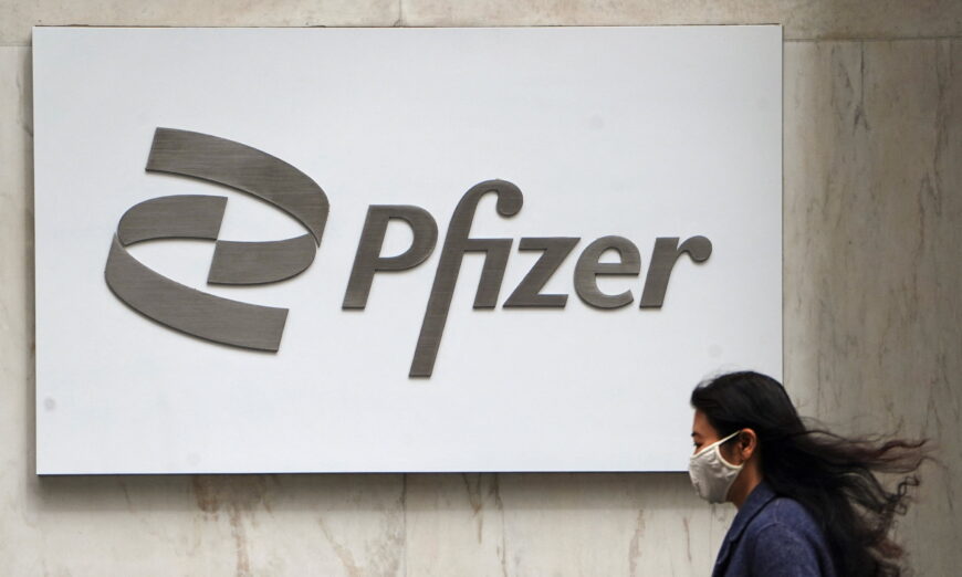 A person walks past a Pfizer logo amid the COVID-19 pandemic in the Manhattan borough of New York, on April 1, 2021. (Carlo Allegri/Reuters)