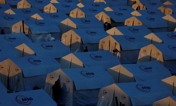 Những người phải di tản đi bộ bên ngoài những túp lều tại một trại dành cho những người sống sót trong trận động đất ở khuôn viên trường đại học KSU Avsar sau trận động đất thảm khốc ở Kahramanmaras, Thổ Nhĩ Kỳ, hôm 09/03/2023. (Ảnh: Susana Vera/Reuters)