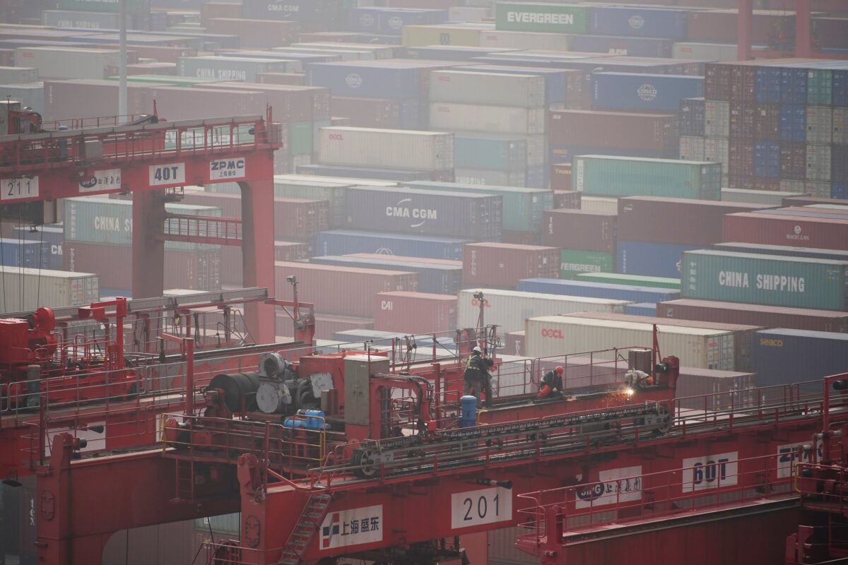 Công nhân trên một chiếc cần cẩu phía trên các container tại Cảng nước sâu Dương Sơn ở Thượng Hải hôm 13/01/2022. (Ảnh: Aly Song/Reuters)