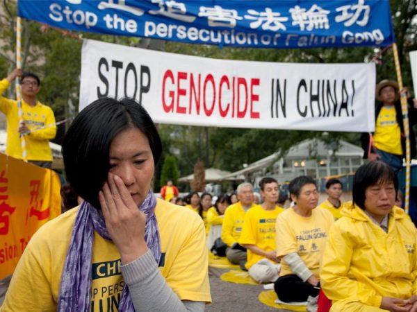 Một học viên Pháp Luân Công lau nước mắt khi nghe một bạn đồng môn kể lại cách cô bị đối xử tàn bạo trong một trại lao động Trung Quốc bên ngoài tòa nhà trụ sở Liên Hiệp Quốc ở Manhattan vào ngày 20/09/2011. (Ảnh: Amal Chen/The Epoch Times)
