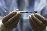 Một người cầm một liều vaccine COVID-19 của Johnson & Johnson trước khi vaccine này được sử dụng trong một cuộc thử nghiệm lâm sàng ở Aurora, Colorado, vào ngày 15/12/2020. (Ảnh: Michael Ciaglo/Getty Images)