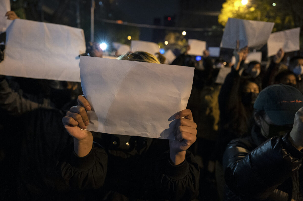 Người biểu tình giơ một tờ giấy trắng chống lại sự kiểm duyệt khi họ tuần hành trong một cuộc biểu tình phản đối các biện pháp zero COVID nghiêm ngặt của Trung Quốc vào ngày 27/11/2022 tại Bắc Kinh, Trung Quốc. (Ảnh: Kevin Frayer/Getty Images)