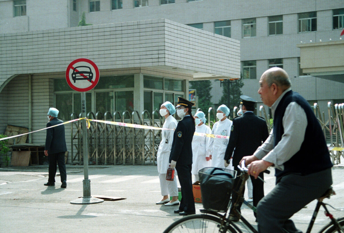 Công an đứng ở lối vào bệnh viện Nhân dân, nơi đã bị phong tỏa do bùng phát dịch SARS ở Bắc Kinh vào ngày 25/04/2003. (Ảnh: Getty Images)