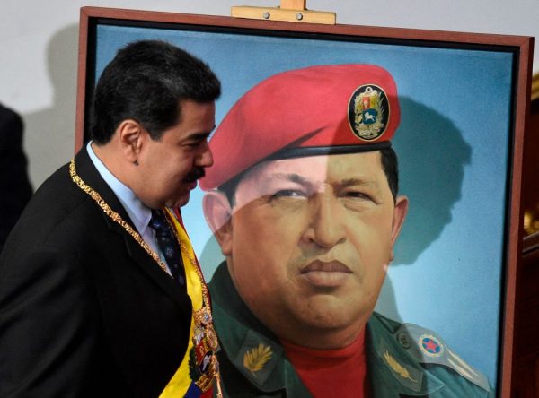 Tổng thống Venezuela Nicolas Maduro đi ngang qua bức chân dung của cố tổng thống Venezuela Hugo Chavez tại Cung điện Lập pháp Liên bang ở Caracas, vào ngày 14/01/2019. (Ảnh: Federico Parra/AFP/Getty Images)