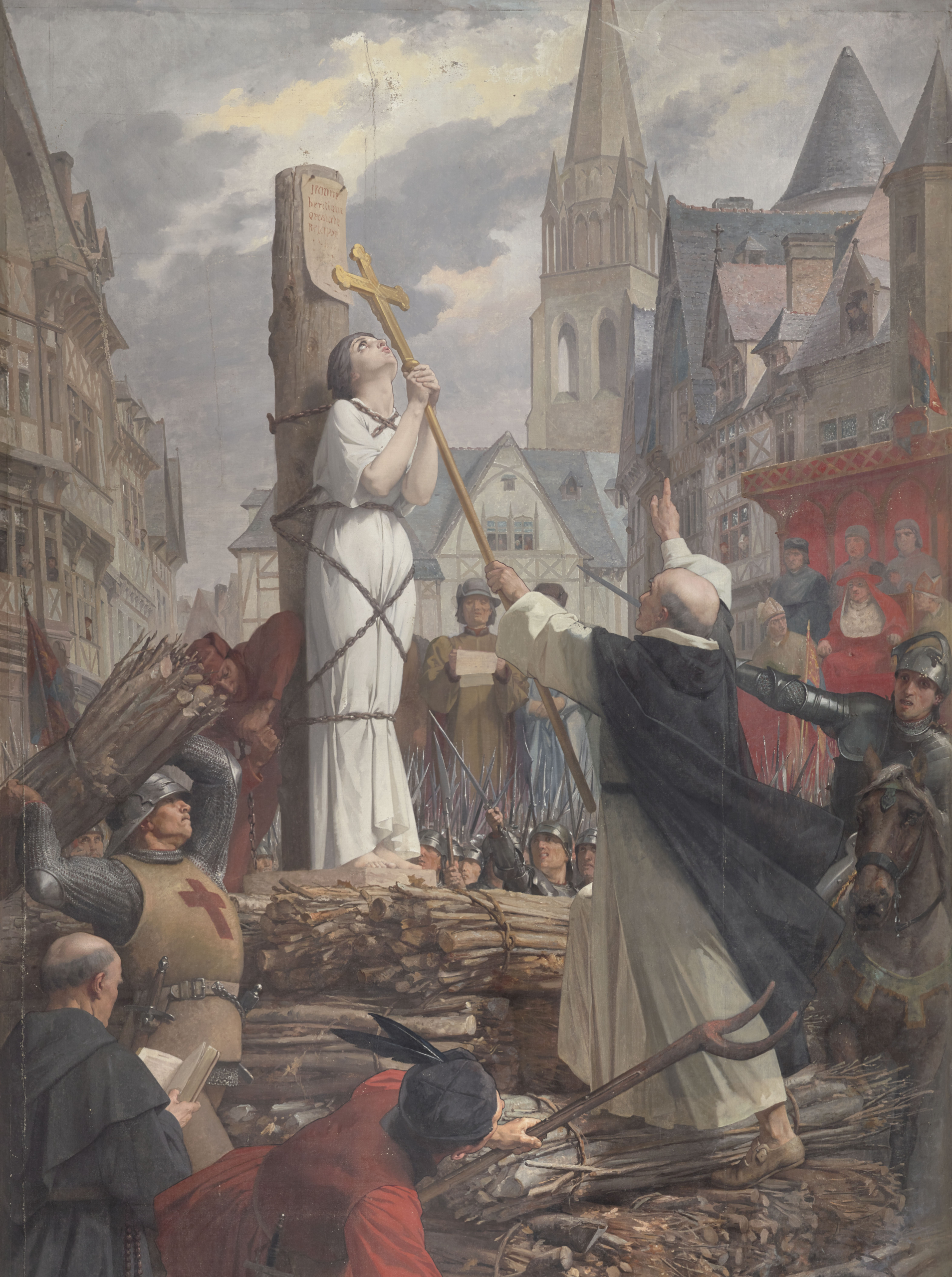 Jeanne d'Arc bị trói vào cột hành hình, tay nắm lấy cây Thánh giá cầu nguyện. Ảnh được vẽ bởi họa sĩ tân cổ điển người Pháp Jules-Eugène Lenepveu. (Ảnh: Tài sản công)
