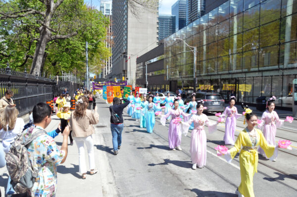Các học viên Pháp Luân Đại Pháp tham gia một lễ diễn hành ở trung tâm thành phố Toronto hôm 06/05/2023 để đánh dấu kỷ niệm 31 năm ngày môn tu luyện tâm linh này được giới thiệu ra công chúng. (Ảnh: Allen Zhou/The Epoch Times)