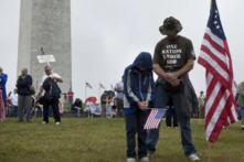 Người dân cúi đầu cầu nguyện trong một cuộc biểu tình ở National Mall gần Đài tưởng niệm Washington vào ngày 12/09/2010 tại Thủ đô Hoa Thịnh Đốn. (Ảnh: Brendan Smialowski/Getty Images)