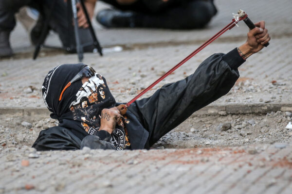Một nhà hoạt động nữ quyền sử dụng súng cao su trong cuộc biểu tình chống bạo lực giới và chế độ gia trưởng ở Santiago hôm 29/11/2019. (Ảnh: Javier Torres/AFP qua Getty Images)