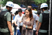 Nhân viên an ninh Trung Quốc kiểm tra danh tính của học sinh vào trường để tham gia kỳ thi tuyển sinh đại học đầy cam go hay còn gọi là Cao Khảo (Gaokao), ở Bắc Kinh, vào ngày 07/06/2012. (Ảnh: STR/AFP/GettyImages)