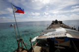 Quốc kỳ Philippines bay phấp phới trên BRP Sierra Madre, con tàu Hải quân rỉ sét bị mắc cạn từ năm 1999 và trở thành một căn cứ quân sự của Philippines trên Bãi cạn Thomas thứ Hai (Bãi Cỏ Mây) đang tranh chấp, một phần của Quần đảo Trường Sa, ở Biển Đông vào ngày 29/03/2014. (Ảnh: Erik De Castro/Reuters)