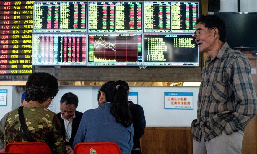 Một nhà đầu tư nhìn vào bảng điện tử hiển thị thông tin chứng khoán tại một công ty môi giới ở Thượng Hải, Trung Quốc, ngày 15/10/2018. (Ảnh: Johannes Eisele/AFP qua Getty Images)
