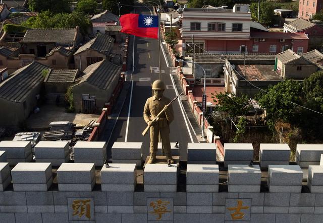 Một bức tượng binh sĩ và quốc kỳ Đài Loan trên đỉnh cổng trại hình vòm được xây dựng để tưởng nhớ Trận Kim Môn (hay Chiến dịch Cổ Ninh Đầu) năm 1949 tại quần đảo Kim Môn của Đài Loan vào ngày 20/10/2020. Quần đảo Kim Môn nằm cách bờ biển Trung Quốc đại lục chỉ 2 dặm (phía sau) tại Eo biển Đài Loan. (Ảnh: Sam Yeh/AFP qua Getty Images)
