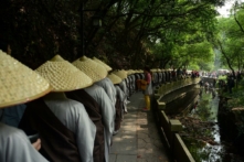 Các tăng ni Phật giáo của Chùa Linh Ẩn đi bộ để nhận lễ vật của Phật tử trong một sự kiện từ thiện kỷ niệm ngày đản sinh Đức Thích Ca Mâu Ni, nhà sáng lập Phật giáo, tại Hàng Châu, tỉnh Chiết Giang, Trung Quốc, vào ngày 25/05/2015. (Ảnh: VCG/VCG qua Getty Images)