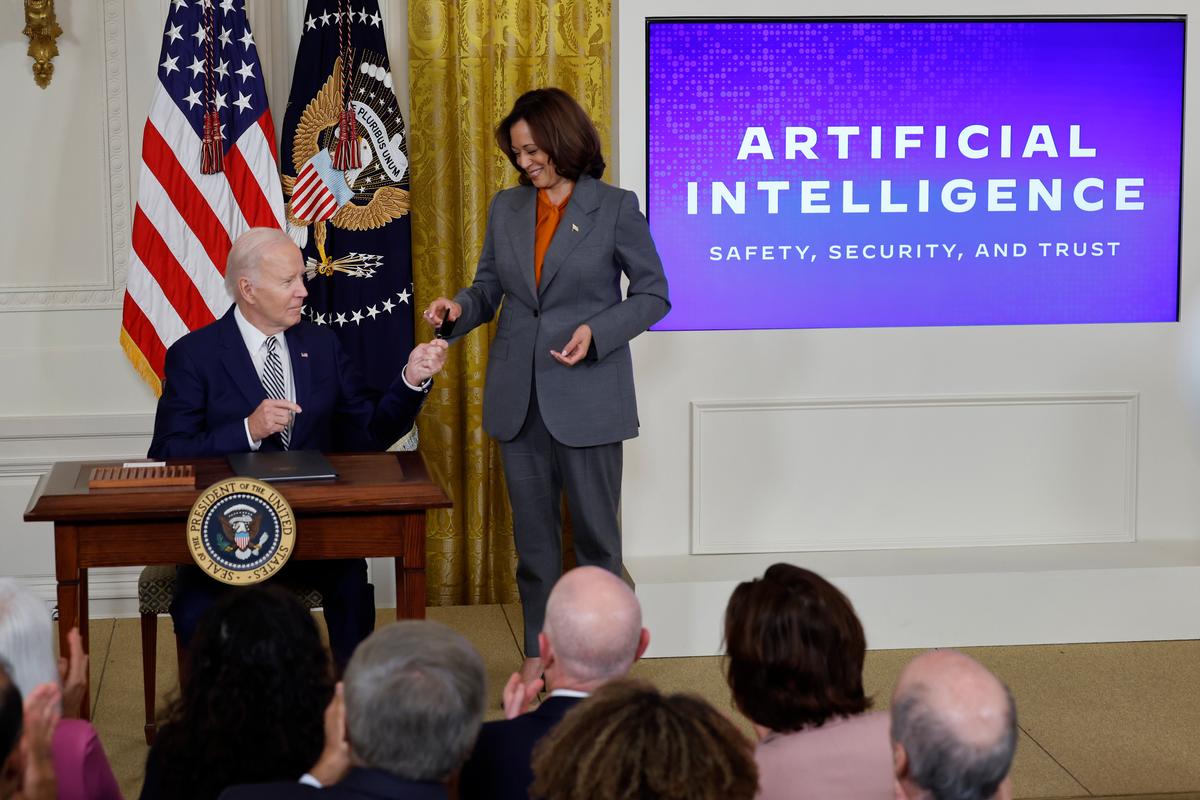 Tổng thống Joe Biden trao cho Phó Tổng thống Kamala Harris chiếc bút mà ông dùng để ký sắc lệnh [hành pháp] mới liên quan đến trí tuệ nhân tạo trong một sự kiện ở Phòng phía Đông của Tòa Bạch Ốc, tại Hoa Thịnh Đốn, hôm 30/10/2023. (Ảnh: Chip Somodevilla/Getty Images)
