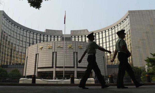 Cảnh sát bán quân sự tuần tra trước Ngân hàng Nhân dân Trung Quốc, ngân hàng trung ương của Trung Quốc, tại Bắc Kinh vào ngày 08/07/2015. (Ảnh: Greg Baker/AFP qua Getty Images)