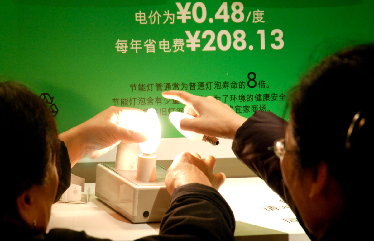 Người mua hàng ở Bắc Kinh kiểm tra bóng đèn tiết kiệm năng lượng tại một cửa hàng gia đình, vào ngày 07/12/2009. (Ảnh: Wang Zhao/AFP qua Getty Images)