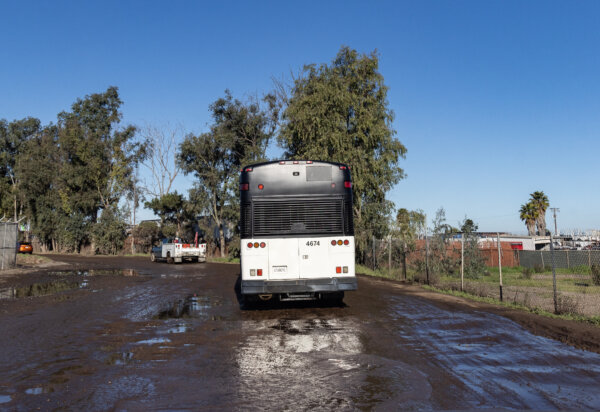 Một chiếc xe bus do nhân viên tuần tra biên giới điều khiển chở những người nhập cư bất hợp pháp đi bên ngoài San Diego, California, hôm 22/02/2024. (Ảnh: John Fredricks/The Epoch Times)