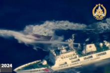 Khung hình này lấy từ các cảnh quay video trên không cho thấy một con tàu của lực lượng Hải cảnh Trung Quốc (dưới cùng bên phải) phun vòi rồng vào con tàu được Hải quân Philippines thuê để thực hiện nhiệm vụ tiếp tế gần Bãi Cỏ Mây (Second Thomas Shoal) thuộc vùng Biển Đông tranh chấp, hôm 23/03/2024. (Ảnh: Lực lượng Vũ trang Philippines/AFP)