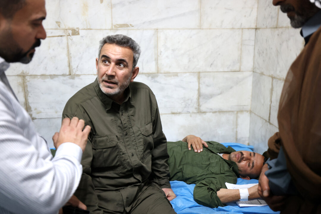 Ông Abu Fadak Al-Mohammedawi (thứ 2 bên trái), tham mưu trưởng Các lực lượng Điều động Nhân dân Iraq đến thăm binh lính tại một bệnh viện ở Hilla, tỉnh miền trung Babylon sau khi họ bị thương trong một vụ nổ trong đêm tại một căn cứ quân sự của Iraq, nơi đồn trú của một liên minh các nhóm vũ trang ủng hộ quân đội Iran, hôm 20/04/2024. (Ảnh: Kaar Jabbar/AFP qua Getty Images)