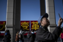 Khách tham quan chụp ảnh trước cổng triển lãm kỷ niệm 40 năm cải cách và mở cửa của Trung Quốc, tại Bảo tàng Quốc gia Trung Quốc ở Bắc Kinh hôm 16/11/2018. (Ảnh: Fred Dufou/AFP)