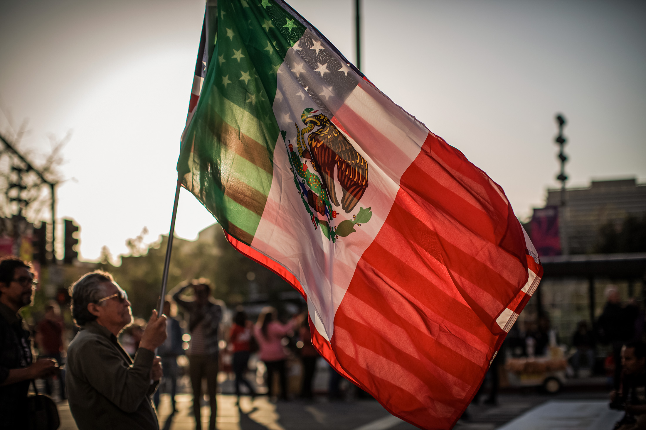 Một người đàn ông cầm quốc kỳ Mỹ và Mexico tại một cuộc tuần hành ở Los Angeles vào ngày 01/05/2019. Người Mỹ gốc Latinh hiện là nhóm thiểu số đông nhất ở Hoa Kỳ. (Ảnh: David McNew/Getty Images)