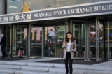 Người dân đi bộ bên ngoài tòa nhà của Sở Giao dịch Chứng khoán Thượng Hải ở Thượng Hải, Trung Quốc, ngày 04/11/2020. (Ảnh: Hector Retamal/AFP qua Getty Images)
